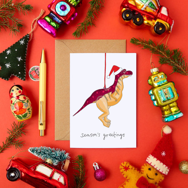 Tarjeta de felicitación navideña con dinosaurios