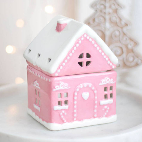 Quemador de aceite navideño con forma de casa de jengibre rosa
