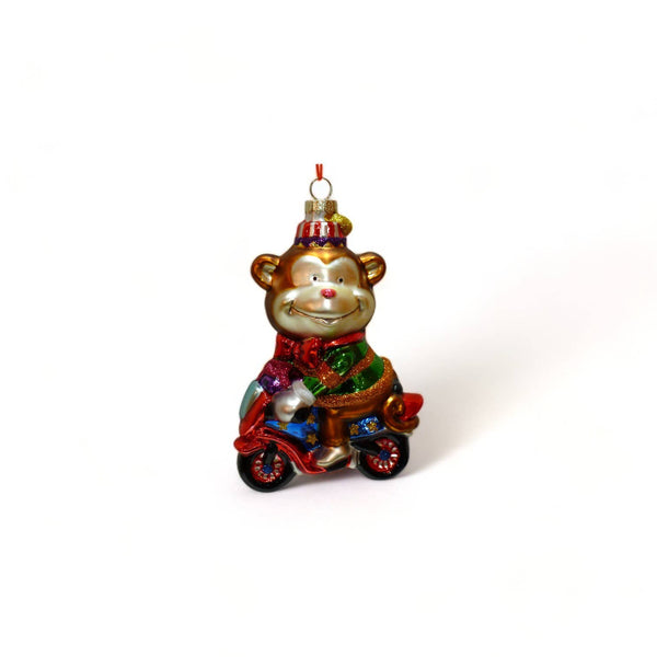 Adorno navideño de mono de circo en motocicleta