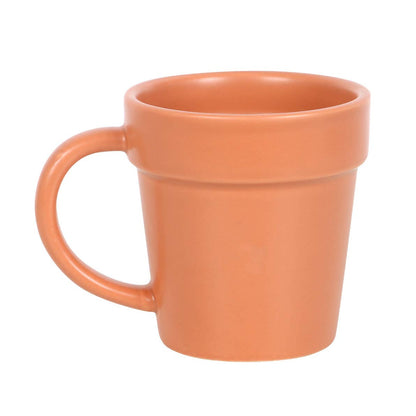 Ceramic cup shaped like a flower pot with a small scoop