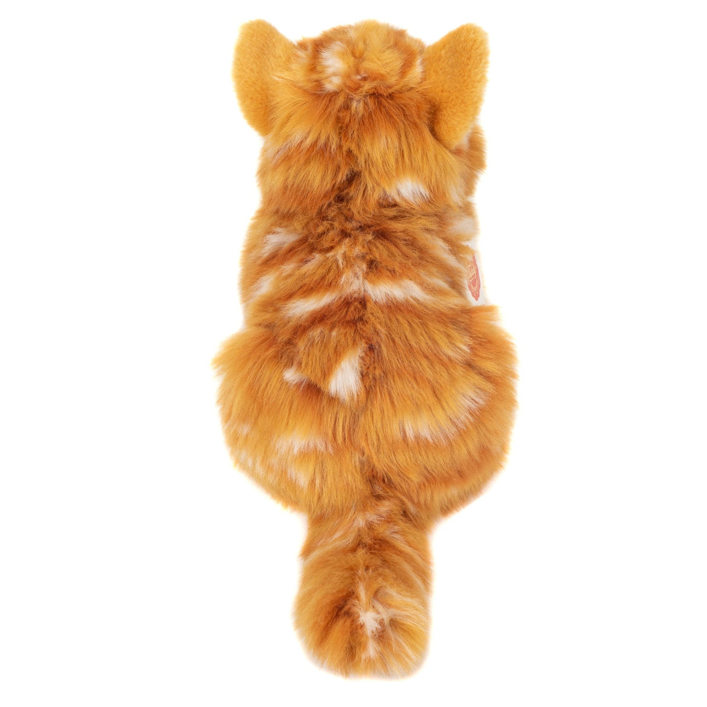 Gatto rosso di peluche sdraiato