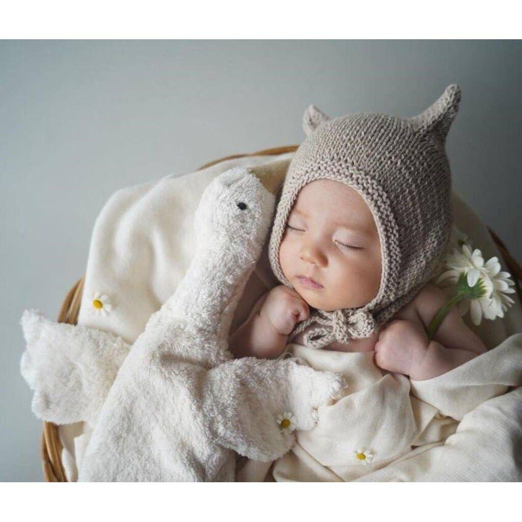 Small hot water bottle in the shape of a cuddly white goose