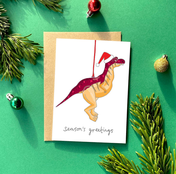 Tarjeta de felicitación navideña con dinosaurios