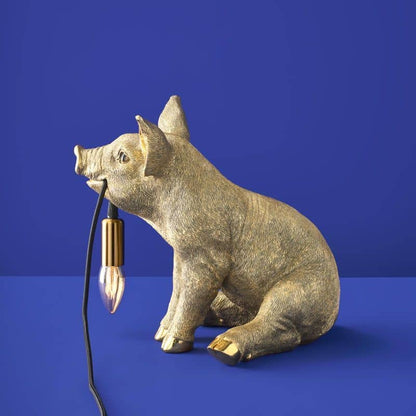 Lampada da tavolo a forma di maiale dorato