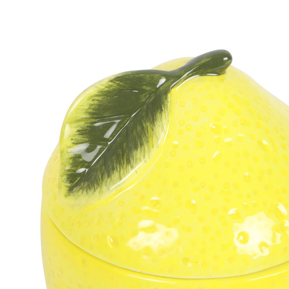 Lemon-colored oil burner with lid