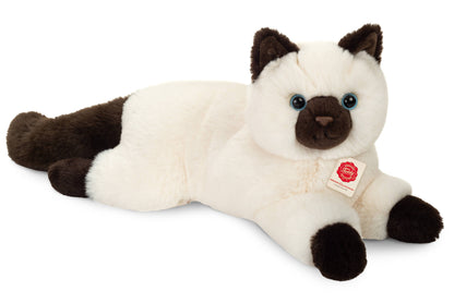 ぬいぐるみの聖なるバーマン猫が横たわっている