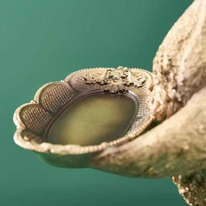 Tarjetero de resina con forma de pato dorado